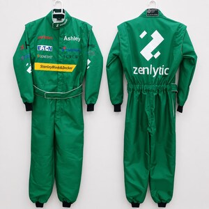 May include: A green racing jumpsuit shown from the front and back. The front features various sponsor logos including Verizon, Eaton, Genesys, and StanleyBlack&Decker. The back displays a large white geometric logo above the text zenlytic.