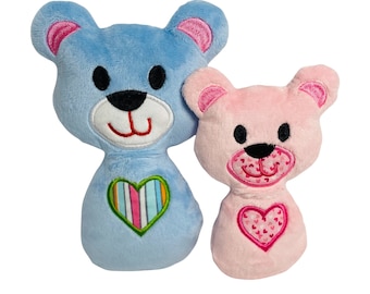May include: Two plush teddy bears, one blue with a striped heart and one pink with a heart filled with smaller hearts.
