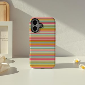 May include: A rectangular smartphone case featuring a vibrant pattern of horizontal stripes in various colours including pink, orange, yellow, light blue, and green. The case has a black camera cutout area at the top left corner with two circular lenses.