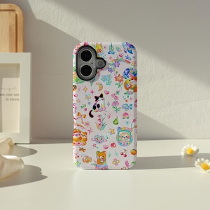 May include: A white phone case adorned with a vibrant, playful design. The case showcases a repeating pattern of cartoon animals, flowers, stars, and other whimsical elements. It has cutouts for the phone's camera and buttons.