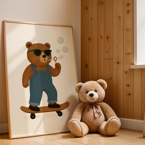 Skateboarding bear nursery wall art digital print displayed in wooden frame next to teddy bear toy - cool bear poster with sunglasses and overalls on skateboard - modern Scandinavian style kids room decor - downloadable children's wall art print for nursery bedroom - cute animal illustration poster instant download - bear skateboard art for boys girls playroom - minimalist nursery decor wooden frame styling - printable kids poster bear theme - digital wall art nursery interior design inspiration