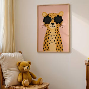 Minimalist nursery wall art - cool leopard with sunglasses print in simple wooden frame, clean modern kids room decor, Scandinavian style animal poster for children's bedroom, neutral nursery artwork with pink background, contemporary baby room wall hanging, simple nursery design with teddy bears, modern animal illustration for toddler room, gender neutral nursery prints, clean aesthetic kids decor, minimalist baby room art, wooden chair nursery furniture styling, bright children's room poster.