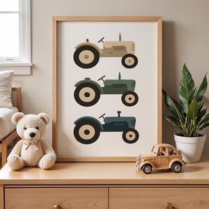 Vintage tractor nursery print on oak dresser with teddy bear wooden toy car and houseplant, farm themed toddler boy room decor styling, three tractors in muted beige olive blue tones, rustic farmhouse kids bedroom shelf decoration, natural wood furniture children's space aesthetic, minimalist vehicle artwork in light oak frame, curated playroom dresser top display ideas, neutral earth tone baby boy nursery inspiration, country style transportation wall art, modern scandinavian farm nursery.