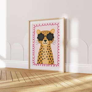 Cheetah nursery wall art print with trendy flower sunglasses - boho kids room decor featuring spotted leopard illustration with pink decorative border, perfect for modern baby girl nursery, toddler bedroom wall decor, safari themed playroom, animal lover children's art, Scandinavian style kids poster, minimalist nursery prints, contemporary child room decoration, wild cat artwork, jungle animal theme, stylish kids wall art, nursery gallery wall, baby shower present, unisex nursery decor.