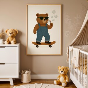Cute skateboarding bear nursery wall art printable – cool bear with sunglasses riding skateboard in denim overalls – digital download poster for baby room, toddler boy bedroom, or gender-neutral nursery – modern minimalist kids wall decor with wooden frame – woodland animal theme nursery art – beige neutral interior baby decor – instant download bear illustration – Scandinavian style nursery print – adorable digital bear poster for children’s room styling.