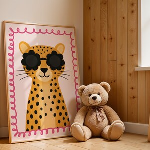 Cute cheetah wall art with flower sunglasses in rustic wooden nursery - adorable leopard print with pink border perfect for natural wood children's room decor, farmhouse style baby nursery, cabin themed kids bedroom, rustic nursery wall art, woodland animal decor, cozy baby room design, Scandinavian nursery style, natural wood paneling nursery, country cottage kids decor, rustic children's art print, wooden nursery furniture styling, warm neutral baby room, natural materials nursery design.