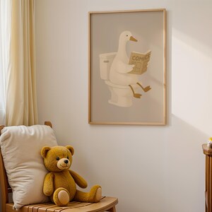 Funny duck bathroom wall art for kids, nursery bathroom decor print, children's toilet humor poster, cute animal reading newspaper art, gender neutral nursery wall decor, baby room bathroom sign, playful duck illustration print, Scandinavian nursery art, minimalist kids bathroom poster, toddler bathroom wall art, warm neutral children's room decor, whimsical duck on toilet print, modern farmhouse nursery artwork, soft beige baby room poster, potty training encouragement art, cozy kids room art.