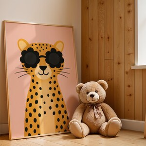 Rustic nursery decor with leopard wall art - spotted cheetah print in wooden frame perfect for cabin nursery, farmhouse kids room decor, natural wood paneling children's bedroom with safari animal poster, cozy nursery wall art with teddy bear, rustic baby room styling, country cottage kids decor, wooden nursery furniture with animal themed art, warm natural nursery design, lodge style children's room poster, vintage inspired nursery prints, rustic animal wall decor, farmhouse baby room art.