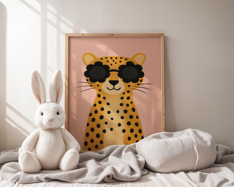 Cozy nursery decor with leopard wall art - spotted cheetah print with sunglasses in soft neutral nursery setting, wooden framed animal poster with white bunny plush toy, gentle nursery styling with cream blankets, calm baby room wall art, soft textures nursery design, peaceful children's bedroom decor, neutral toned animal themed nursery, comforting baby room artwork, serene nursery wall hanging, white and pink nursery color scheme, gentle safari animal print, soothing kids room poster.