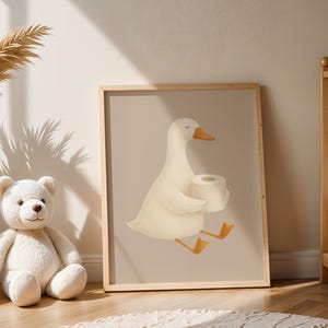 Funny goose bathroom wall art, white goose carrying toilet paper print, humorous kids bathroom decor, playful goose illustration for children's bath, gender neutral bathroom wall art, quirky farmhouse bathroom poster, Scandinavian nursery goose print, cute animal bathroom humor art, modern farmhouse kids bathroom, whimsical goose nursery decor, natural wood frame bathroom art, silly goose wall print for toddlers, cottage style children's bathroom, neutral beige goose illustration.