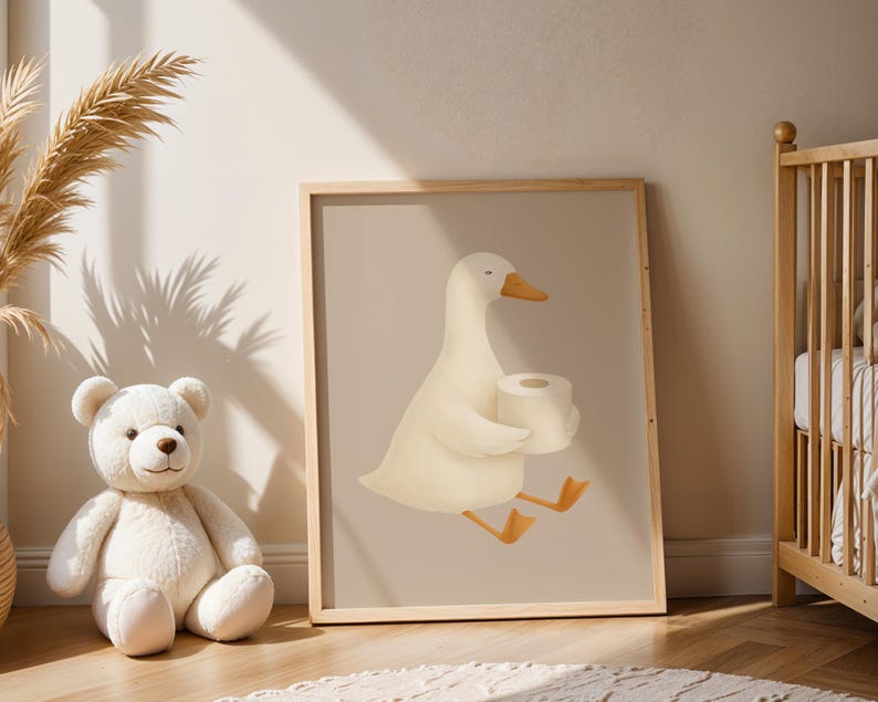 Funny goose bathroom wall art, white goose carrying toilet paper print, humorous kids bathroom decor, playful goose illustration for children's bath, gender neutral bathroom wall art, quirky farmhouse bathroom poster, Scandinavian nursery goose print, cute animal bathroom humor art, modern farmhouse kids bathroom, whimsical goose nursery decor, natural wood frame bathroom art, silly goose wall print for toddlers, cottage style children's bathroom, neutral beige goose illustration.