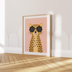 Safari nursery wall art print - cool leopard with sunglasses kids room decor, boho animal poster for baby nursery, trendy spotted cat illustration, modern children's wall decor, pink background nursery art, wooden frame kids bedroom print, wild animal themed nursery decor, stylish baby room artwork, contemporary jungle animal wall art, leopard nursery print, kids safari decor, animal lover gift, nursery gallery wall art, bohemian children's room poster, cute cat print for playroom.