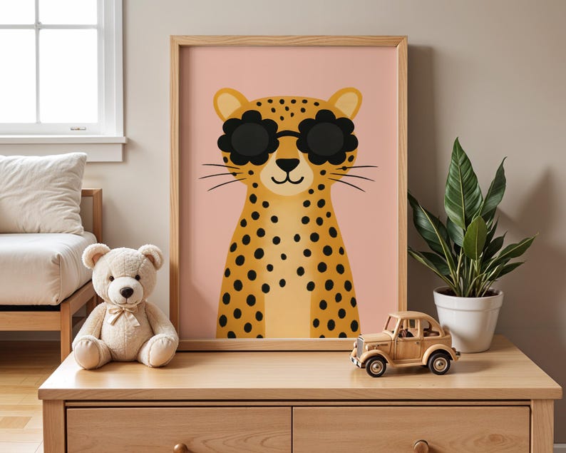 Modern nursery shelf styling with leopard wall art - cute spotted cheetah print with sunglasses on wooden dresser, boho kids room decor with snake plant and wooden toy car, contemporary animal poster for toddler bedroom, pink background safari nursery art, natural wood frame children's wall decor, modern nursery furniture styling ideas, plant parent nursery decor, trendy kids room accessories, wooden toys and animal prints nursery theme, stylish baby room wall hanging, jungle themed nursery.