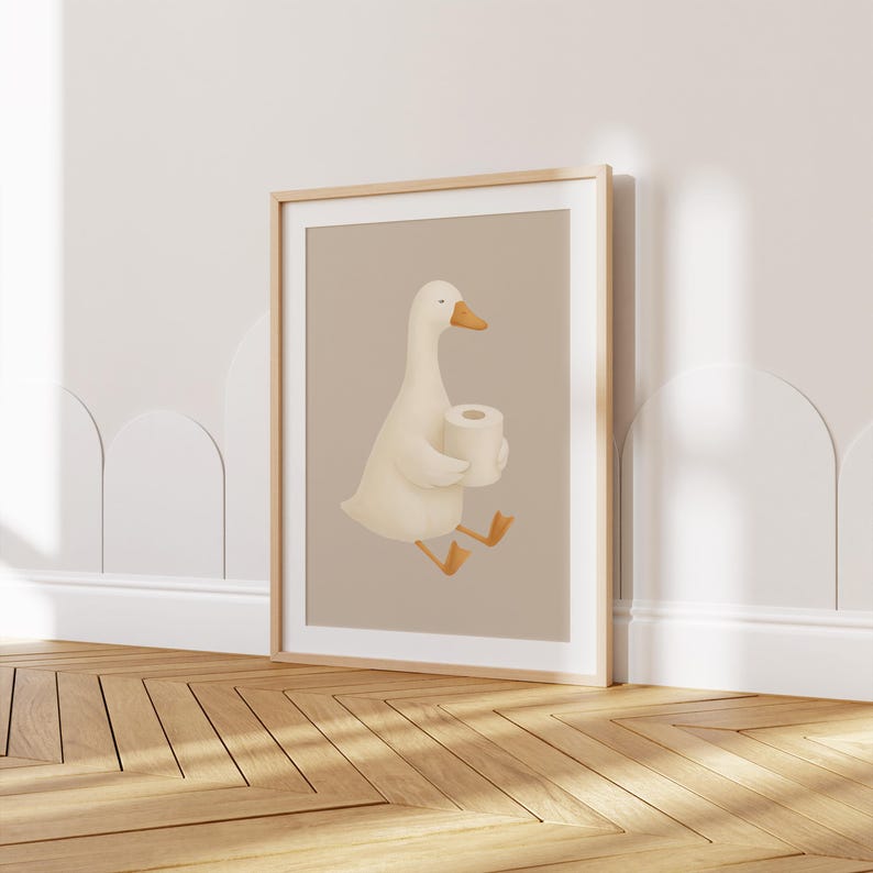 White goose bathroom wall art for kids, playful walking goose print for children's bathroom, gender neutral kids bathroom decor, minimalist goose illustration nursery art, farmhouse style children's bathroom poster, cute goose print for toddler bathroom, Scandinavian kids bathroom wall decor, natural wood frame goose art, neutral beige goose bathroom print, whimsical farm animal bathroom art, modern farmhouse kids bath decor, simple goose illustration for child's room.