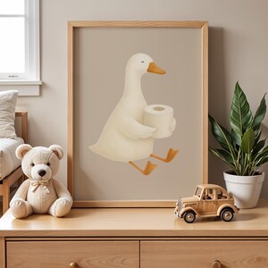 Goose holding toilet paper wall art, funny bathroom decor for kids, humorous potty training print, quirky children's bathroom poster, playful goose toilet paper illustration, gender neutral bathroom humor art, whimsical farmhouse kids bath decor, cute animal bathroom joke print, modern nursery bathroom wall art, Scandinavian style funny bathroom poster, wooden frame toilet humor for children, lighthearted potty training encouragement, charming kids bathroom wall decor, silly goose bathroom art.