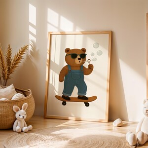 Boho nursery wall art printable featuring a cute bear with sunglasses blowing bubbles while riding a skateboard. Perfect digital download for modern baby room, toddler boy decor, or woodland animal nursery theme. Neutral tones, Scandinavian style, cozy natural nursery setting with plush toys and wicker basket. Ideal kids room artwork for gender-neutral decoration, instant download, and stylish interior design for children.