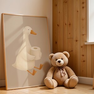 Goose bathroom wall art for kids room, humorous white goose with toilet paper print, funny children's bathroom decor, rustic farmhouse kids bath art, playful goose illustration nursery, wooden frame bathroom humor poster, Scandinavian style kids bathroom wall art, quirky animal bathroom print, natural wood paneling nursery design, cute goose potty training decor, modern farmhouse children's bathroom, whimsical farm animal art for toddlers, gender neutral bathroom wall decor.