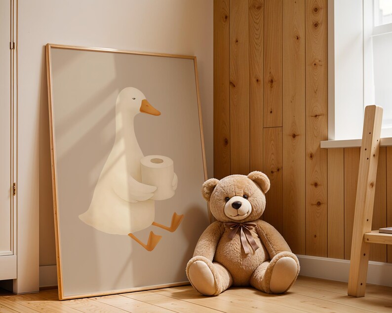 Goose bathroom wall art for kids room, humorous white goose with toilet paper print, funny children's bathroom decor, rustic farmhouse kids bath art, playful goose illustration nursery, wooden frame bathroom humor poster, Scandinavian style kids bathroom wall art, quirky animal bathroom print, natural wood paneling nursery design, cute goose potty training decor, modern farmhouse children's bathroom, whimsical farm animal art for toddlers, gender neutral bathroom wall decor.