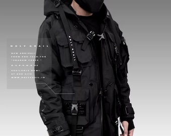 May include: A black hooded jacket with multiple straps and buckles. The jacket has a large pocket on the front and a smaller pocket on the left sleeve. The jacket is labelled "HOLY GRAIL" on the front and back.  NEW ARRIVAL FROM PRO-TECH-TOR "SHADOW FORCE" H.G.W.M.004 AVAILABLE NOW! AT OUR SITE WWW.HOLYGRAIL.ID