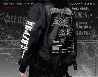 May include: A black jacket with white text that reads "Cyber Not Dead" and "Holy Grail". The jacket has a zip and multiple pockets. The jacket is being worn by a person with a black hoodie underneath. The background is a black and white graphic pattern.