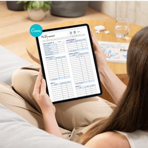 May include: A tablet displaying a "Monthly Budget" template is held by a person. The template includes sections for income and expenses. The tablet is black with a white screen, and the text is in black. The Canva logo is visible in the upper left corner.