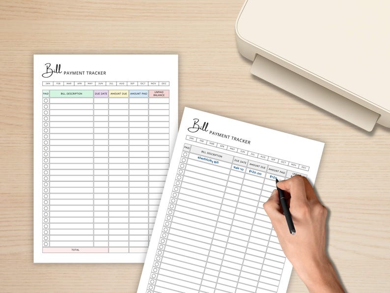 May include: Two white bill payment tracker sheets with a light beige background. The sheets have a header that says "Bill Payment Tracker". One sheet is being written on with a black pen. The sheets are next to a white printer.