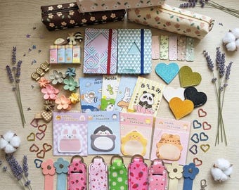 May include: A collection of stationery items including three rectangular fabric pencil cases with floral patterns, two small notebooks with elastic bands, various animal-themed sticky notes, heart-shaped glitter patches, and several colorful floral-patterned keychains.