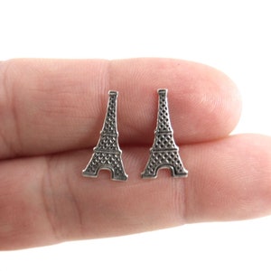 May include: A pair of silver Eiffel Tower stud earrings. The earrings are small and delicate, and they would make a great gift for anyone who loves Paris.