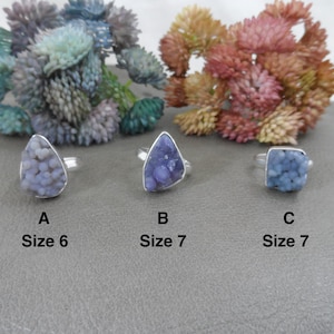 May include: Three silver rings with purple and blue agate stones. The rings are labelled A, B, and C. Ring A is size 6, ring B is size 7, and ring C is size 7.