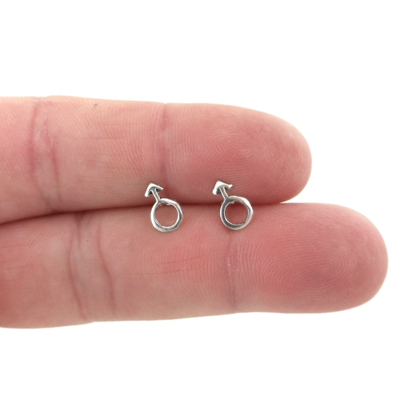 May include: A pair of silver stud earrings with a male symbol design.
