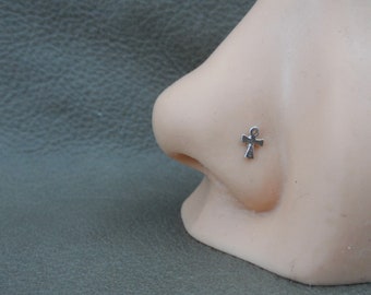 May include: Silver nose ring with an ankh charm.