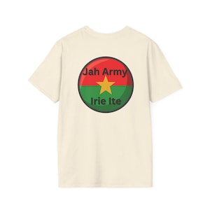 May include: Cream-colored t-shirt featuring a circular graphic with the text "Jah Army" in red, "Irie Ite" in green, and a gold star. The graphic is set against a red and green background.