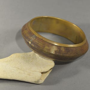 Vintage brass bracelet in ethnic style