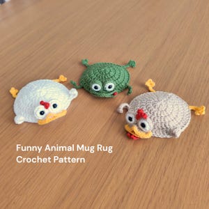 May include: Three handmade crochet animal mug rugs. The rugs are shaped like a white chicken, a green frog, and a tan chicken. Each has large googly eyes and yellow accents. The text "Funny Animal Mug Rug Crochet Pattern" is at the bottom.