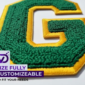 May include: A letter G patch featuring a textured dark green chenille center with a smooth yellow embroidered border. The patch includes a white overlay graphic with the text VD, SIZE FULLY CUSTOMIZABLE TO FIT YOUR NEEDS in purple and black.