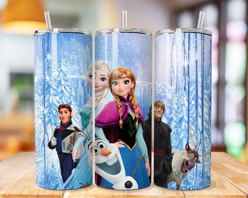 May include: A set of three stainless steel tumblers with a winter wonderland design featuring characters from the film Frozen. The tumblers feature Elsa, Anna, Olaf, Kristoff, and Sven. The background is a blue and white winter scene with snow-covered trees.