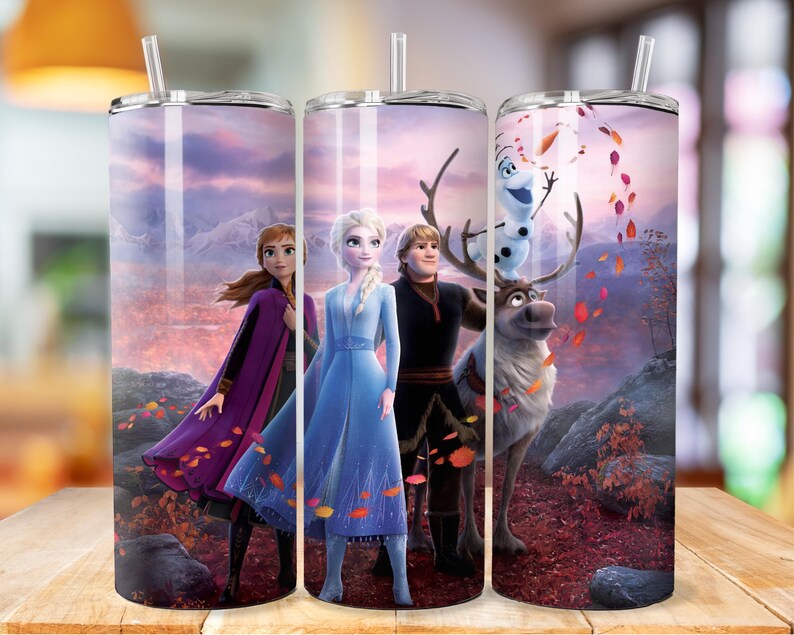 May include: Three stainless steel tumblers featuring a colourful image of characters from the film Frozen. The image shows Elsa, Anna, Kristoff, and Olaf standing in a snowy forest with a reindeer.
