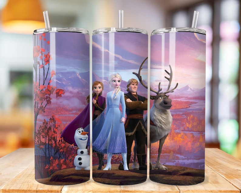 May include: Three stainless steel tumblers with a Frozen theme. The tumblers feature a purple, pink, and blue sunset background with Elsa, Anna, Kristoff, and Olaf. A reindeer is also featured in the image.