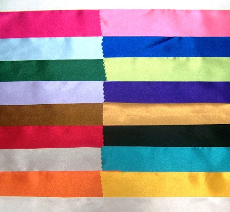 May include: A collection of 14 different colored satin ribbon samples. The ribbons are arranged in rows, with each row featuring a different color. The colors include pink, light blue, dark blue, green, lavender, brown, red, silver, turquoise, orange, and yellow.