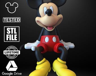May include: A 3D-rendered Mickey Mouse figure with black ears, a black body, red shorts, yellow shoes, and white gloves. The image includes the text "STL ARCHIVE 3D" and icons for "TESTED", "STL FILE", "WARRANTY", and "Google Drive".