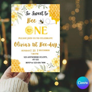 May include: A white invitation card with yellow and gold accents, featuring the text "So Sweet to Bee One" and "Olivia's 1st Bee-day." The design includes illustrations of bees, honeycombs, and flowers. The card also includes event details.