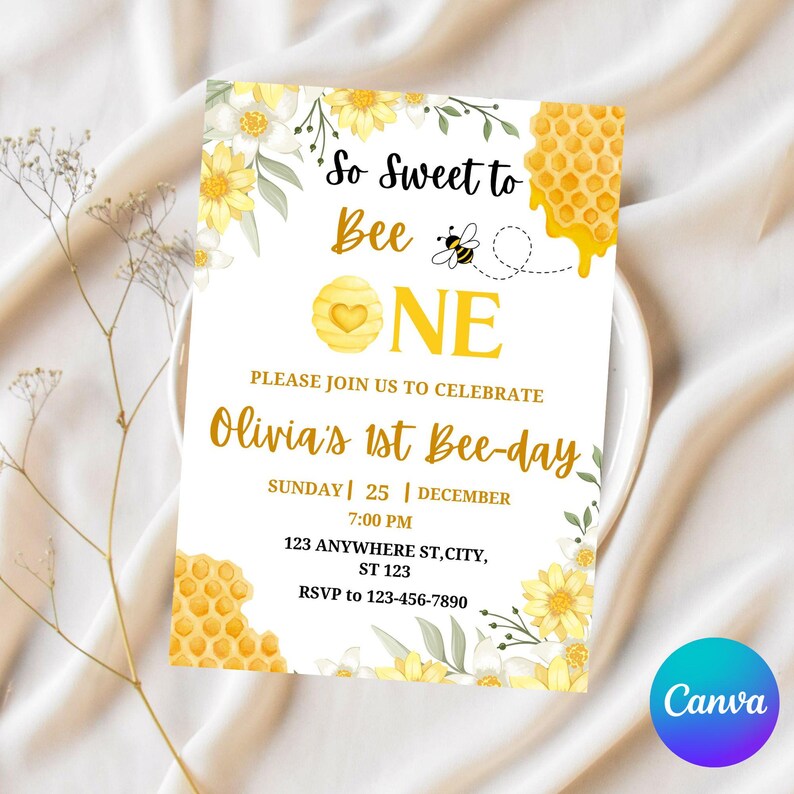 May include: A white invitation card with a bee theme. The card features yellow and white floral accents, honeycomb graphics, and the text "So Sweet to Bee One" and "Olivia's 1st Bee-day". Includes event details and RSVP information.