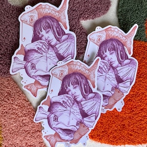 May include: Three stickers featuring a woman holding a fish. The woman has long dark hair and is wearing a dress. The fish are pink and purple and have a detailed design. The stickers are on a white background.