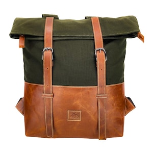 May include: A roll-top backpack with a green canvas upper and a brown leather lower section. The bag features brown leather straps with silver buckles and a small leather patch with a mountain logo.