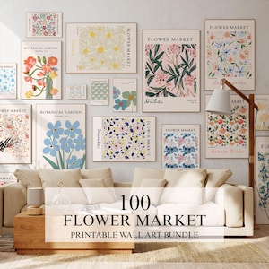 May include: A collection of various rectangular wall art prints featuring floral illustrations and botanical designs with text labels like Flower Market, Botanical Garden, Dubai, and Mumbai, displayed in a gallery wall arrangement above a sofa.