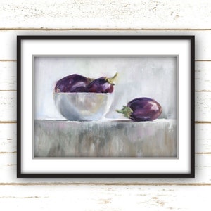 May include: A framed still life painting featuring a white bowl filled with several purple eggplants. One eggplant rests beside the bowl. The painting has a soft, muted color palette with a focus on the eggplants' rich purple hues.