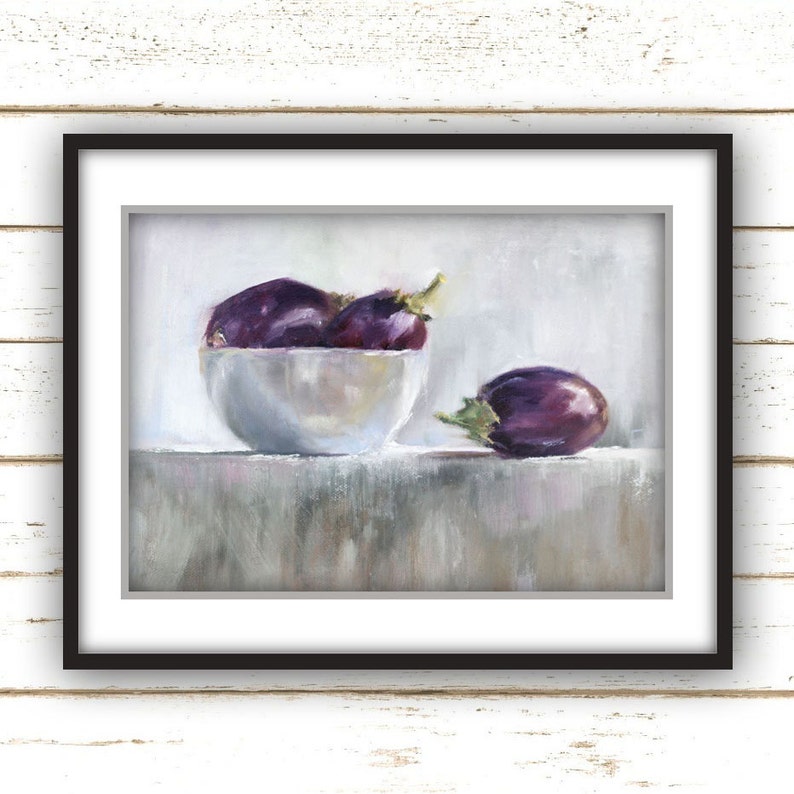 May include: A framed still life painting featuring a white bowl filled with several purple eggplants. One eggplant rests beside the bowl. The painting has a soft, muted color palette with a focus on the eggplants' rich purple hues.