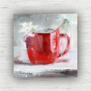 May include: An oil painting of a red mug with a handle, filled with white flowers and green stems. The artwork has a textured, brushstroke style, with a signature in the bottom left corner. The background is a soft blend of gray and white.