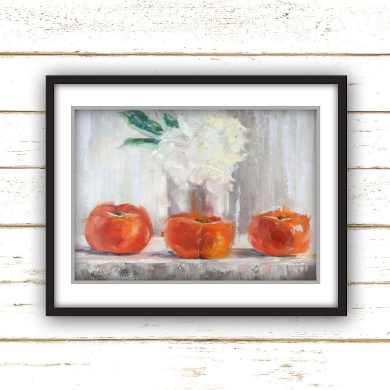 May include: A framed still life painting featuring three vibrant orange persimmons in the foreground. A vase of white flowers sits in the background. The artwork is set against a neutral, textured backdrop.