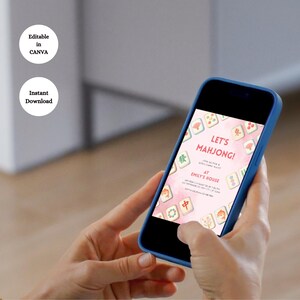 May include: A smartphone displays a pink invitation for a Mahjong game night. The invitation features Mahjong tiles and the text "Let's Mahjong!" with details about the event. The phone is held in a blue case.